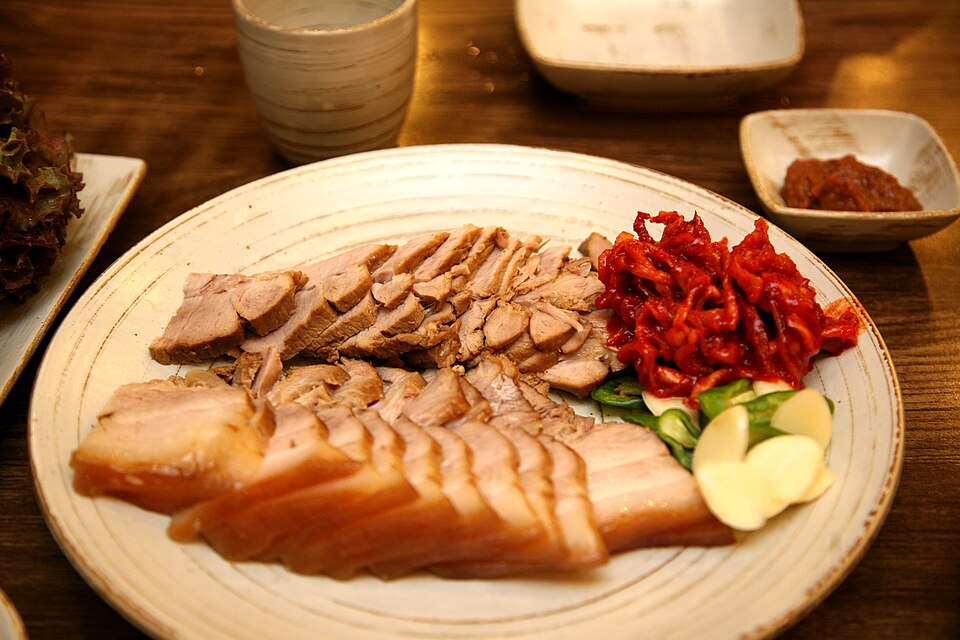 Korean boiled pork slices with savory table setting